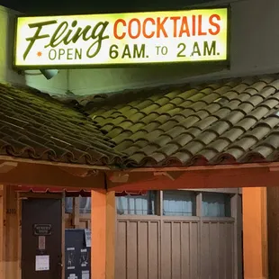 a neon sign above a closed door