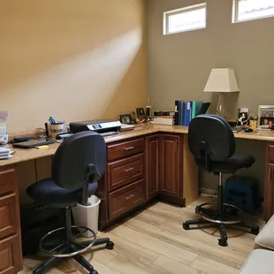 a corner office with a desk and chair