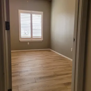 an empty room with a ceiling fan