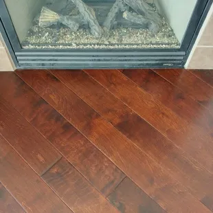 Up against the fireplace.