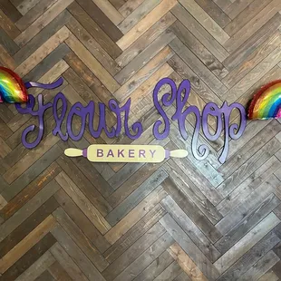 a rainbow - colored sign