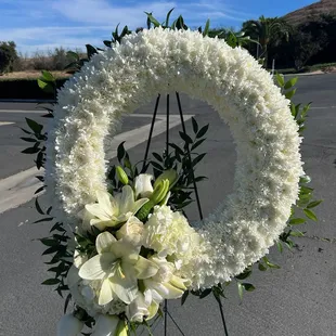 Solid Wreath Made of cushion mums w/accent piece.