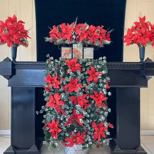 Christmas cemetery matching monument saddle, side urns and casket blanket with frosted greenery. One of our newest services!