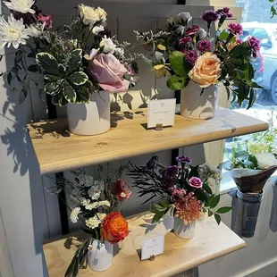 Display of small arrangements for sale that are curated frequently.