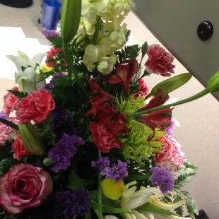 Pick rose, lilies, and a carnation of flowers mixed in. Well organized &amp; nicely put together.