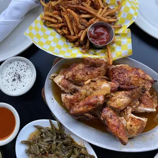 a plate of chicken wings, french fries, and green beans