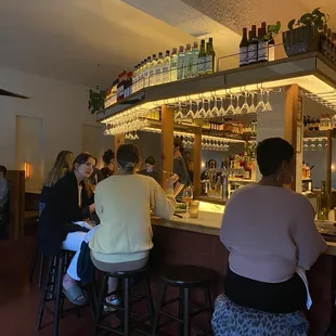 a group of people sitting at a bar