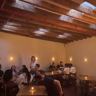 a group of people sitting at tables in a restaurant