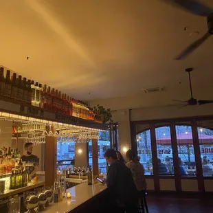 people sitting at a bar in a restaurant