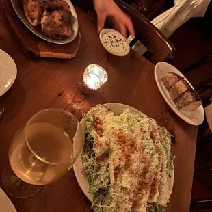 Caesar salad and half chicken and bread and white sauce