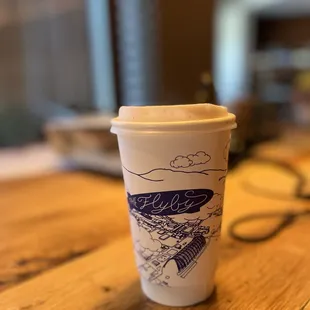 Mystery drink in soy ink, compostable, cafe branded cup