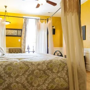 The Giovanni Room has a romantic draped king bed. The walls are reminiscent of old Tuscan plaster