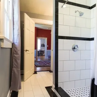 Beautiful tiled bathroom with large walk-in shower adjoins the 1940&apos;s Paris Room