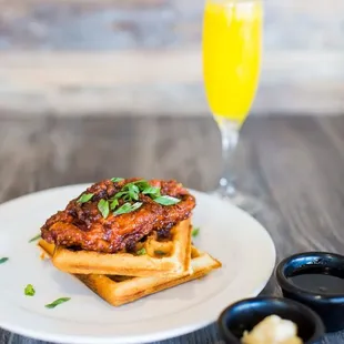 a plate of food and a glass of orange juice