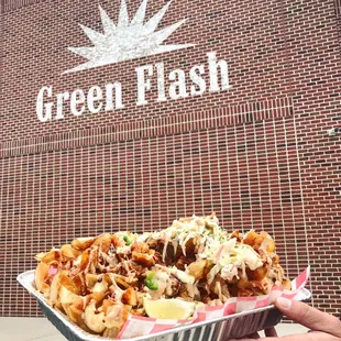 a person holding a tray of food