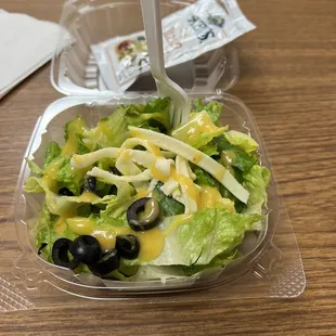 a salad in a plastic container