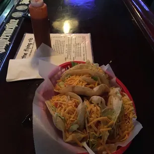a plate of tacos and a drink