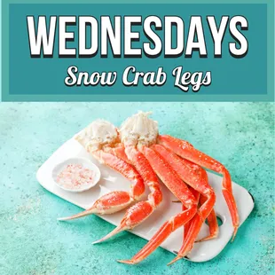 snow crab legs on a plate with dipping sauce