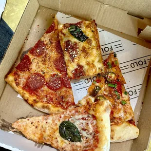 three slices of pizza in a box