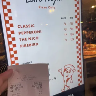 The sign at the window vs. what was charged.