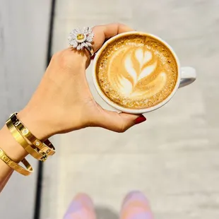 a woman holding a cup of coffee