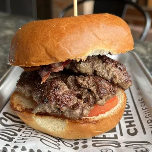 burger with bacon, tomato, and beef