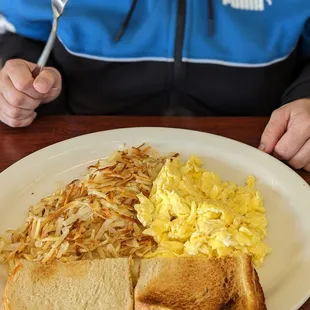 Breakfast plate. Eggs, hash browns and toast