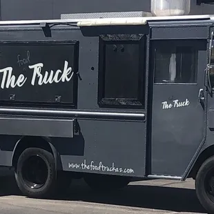 a black truck parked in front of a building