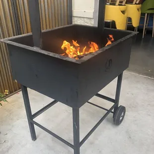 a grill with flames in it
