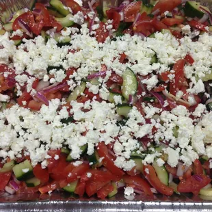 Our Cucumber Salad with Roma tomatoes, red onion and feta. Dressed with our house Italian.