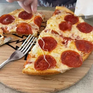 a slice of pepperoni pizza