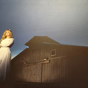 A bride infront of the Stables at Forevermore Farm