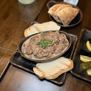 Drunken mushrooms - mushrooms stewed in red wine, onions, spices, herbs, cream, served with crostini