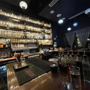 a bar with liquor bottles on the shelves