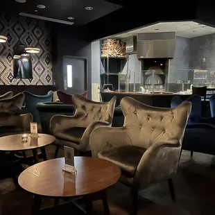 a view of a bar with chairs and tables