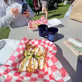 a woman taking a picture of a sandwich
