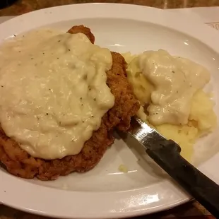 Chicken fried steak with side of mashed potatoes.