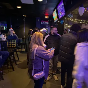 a group of people at a bar