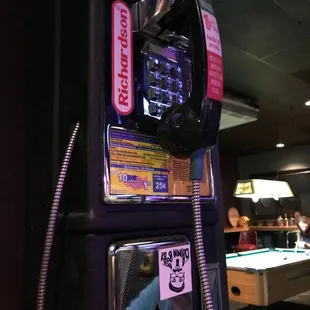 a payphone with a man in a blue shirt