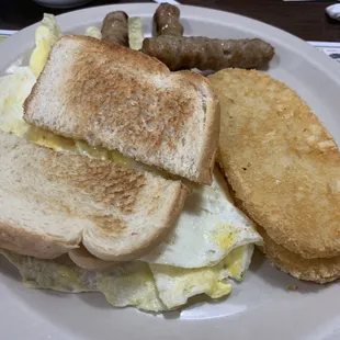 Scrambled eggs, sausage, hash-browns and toast