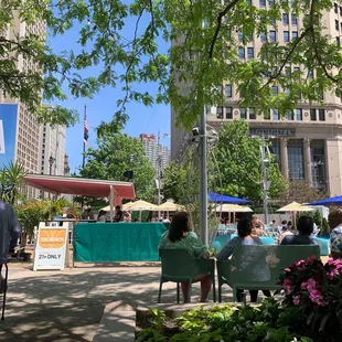 people sitting in chairs under umbrellas