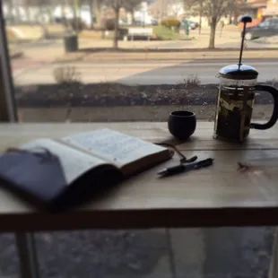 a cup of coffee and an open book