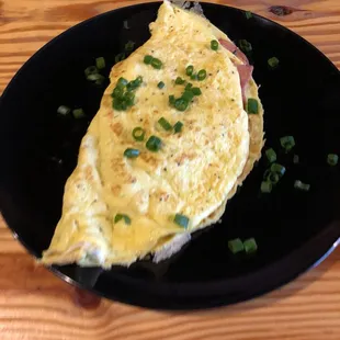 an omelet on a black plate