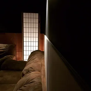 a dark room with a couch and a bed