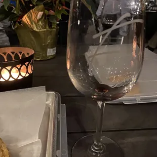 a glass of wine and a pastry