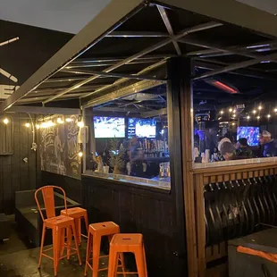 a bar with orange chairs
