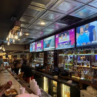 people watching tvs at the bar