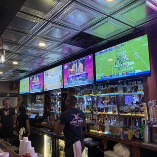 people watching sports on tvs