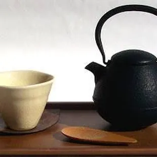 a teapot and a cup on a tray