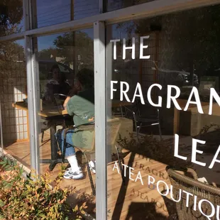 a person sitting at a table outside